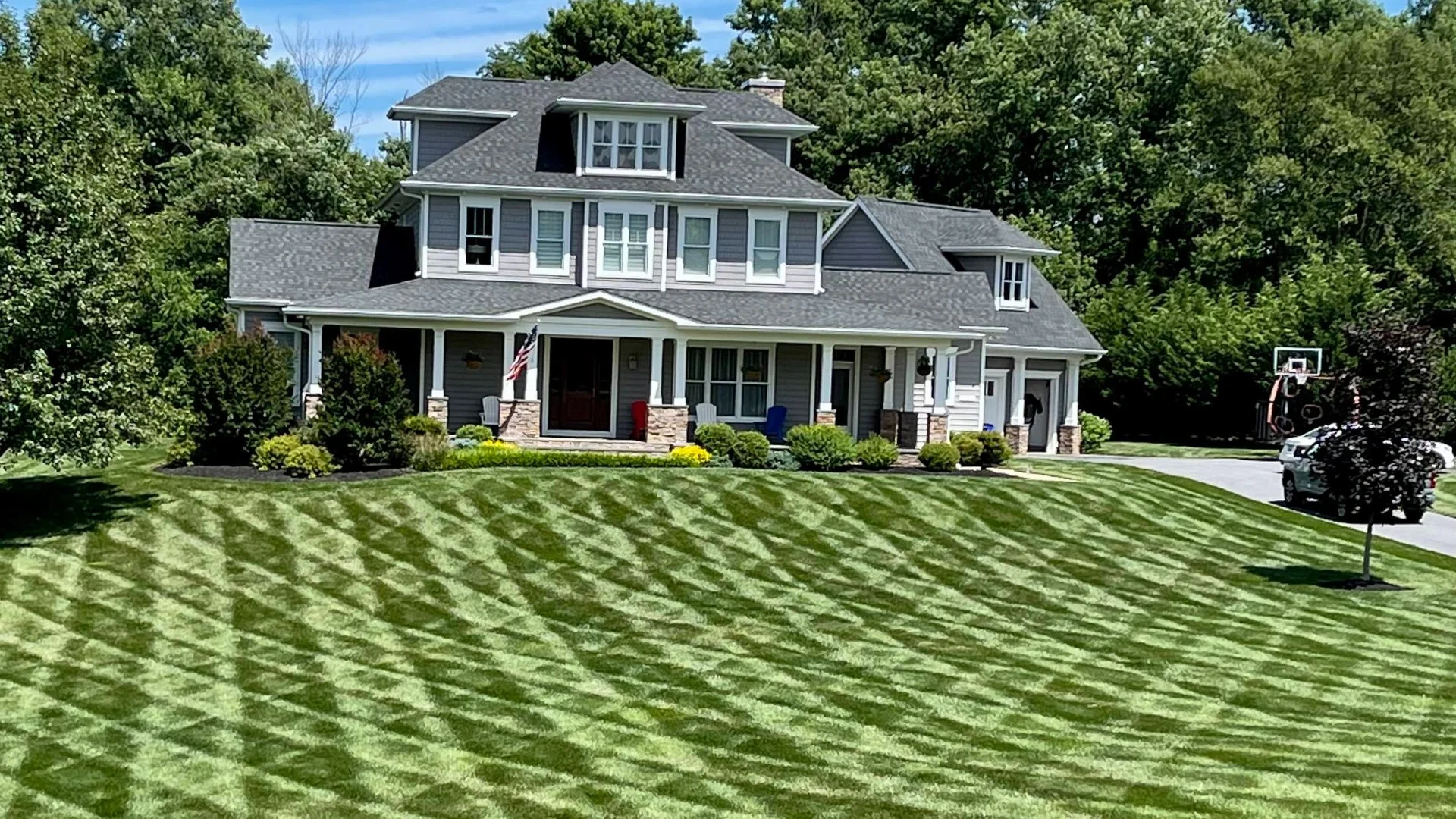 Green lawn in front of a gray house in Clarksville, MD.