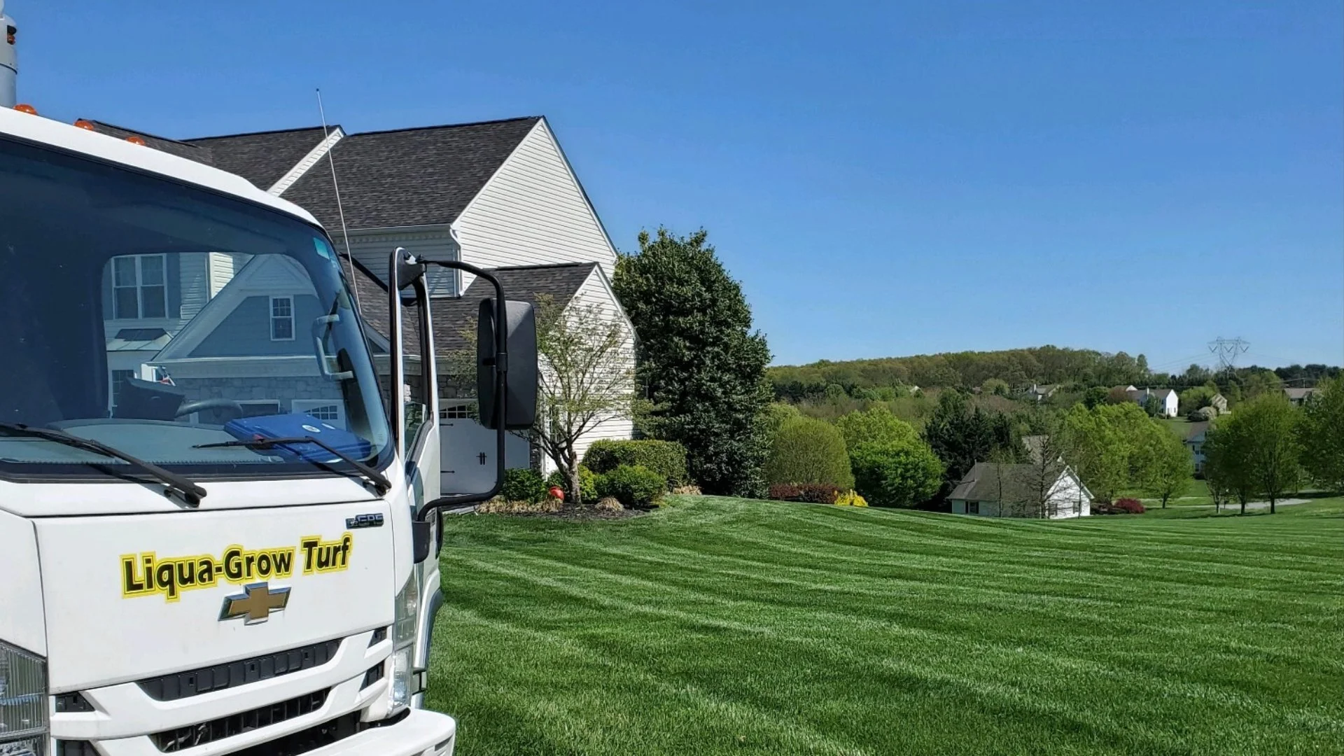 Truck at a home for tree insect control services.