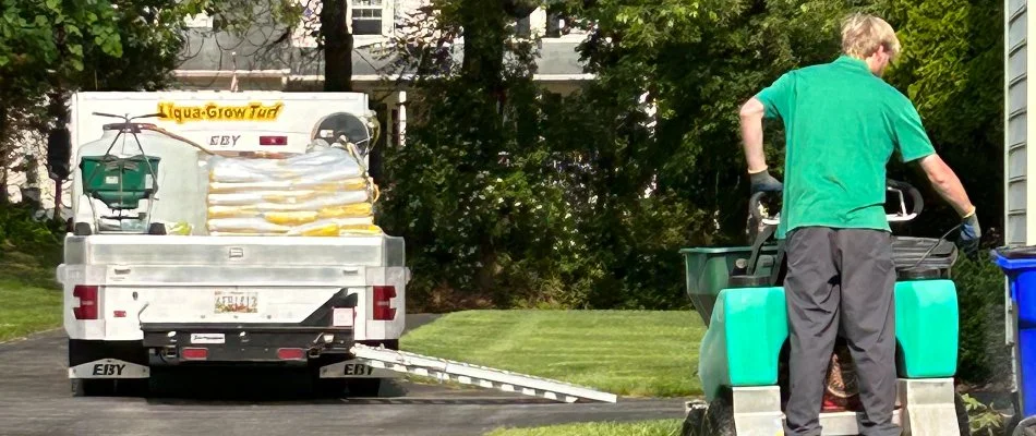 Crew applying granular fertilizer on a lawn in Eldersburg, MD.