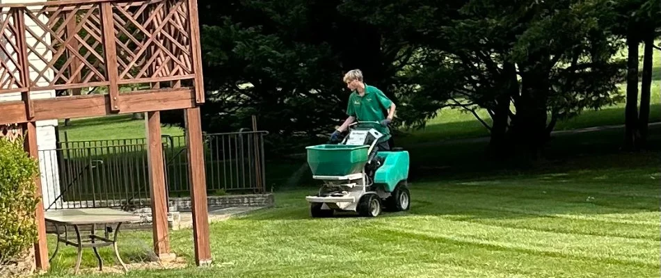 Crew applying lawn fertilizer treatment in Glenelg, MD.