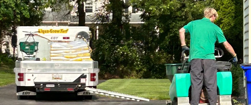 Crew spraying lawn fertilizer treatment in Westminster, MD.