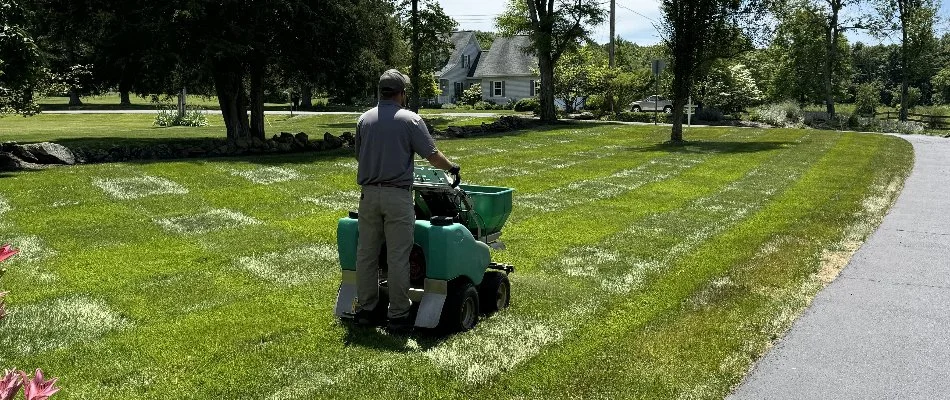 Man on a fertilizer spreader machine in Cockeysville, MD.