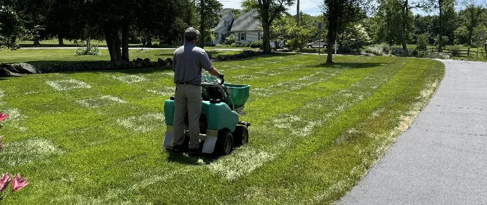 Tech on lawn care equipment going over grass in Deale, MD.